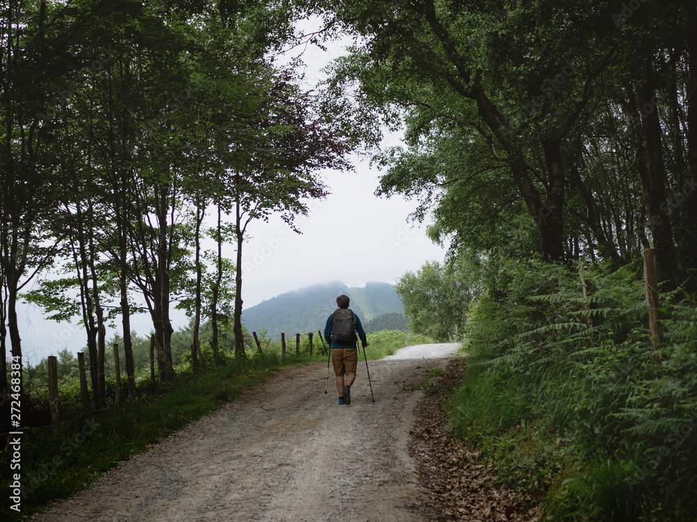 Young man hiking on a foggy day Young man hiking on a foggy day