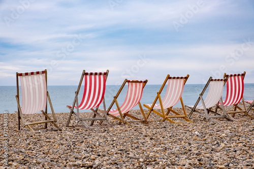 Fototapeta Naklejka Na Ścianę i Meble -  Deckchairs on beach at english seaside