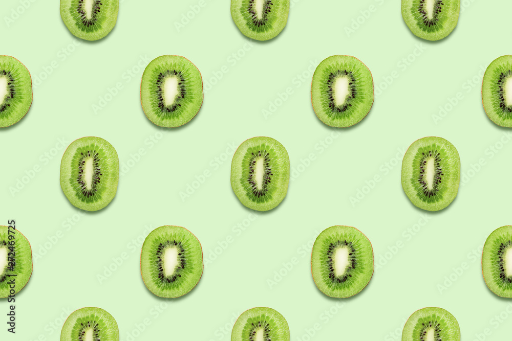 Kiwi slices. Tropical seamless pattern on green background. Minimal summer concept. Flat lay, trendy juicy color. Kiwi slices. Tropical seamless pattern on green background. Minimal summer concept. Flat lay, trendy juicy color.