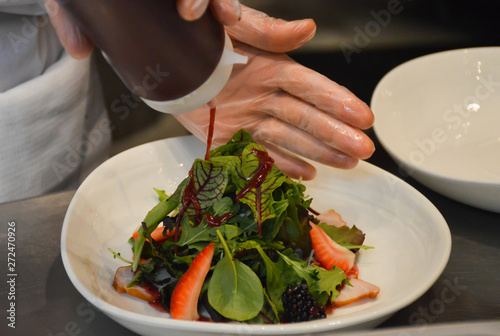 chef preparing salad from ham and leaf lettuce