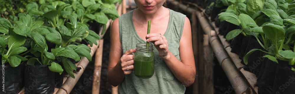 © Alexander Grabchilev/Stocksy - Woman Drinks Green Juice