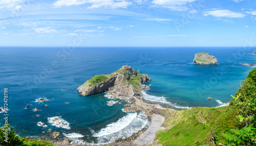 sunny day at gaztelugatxe island, located at basque country coastline photo