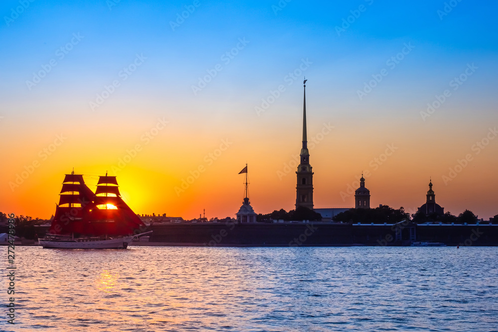 Saint Petersburg. Holiday Scarlet Sails. Russia. Sailboat sailing on the Neva River. Rasvet the sun on the background of the Peter and Paul Fortress. Holidays in the Russian Federation.