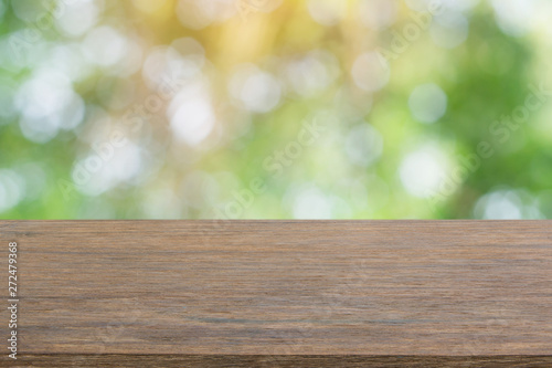 Empty dark wood table top and blur nature background with copy space for display or montage your products