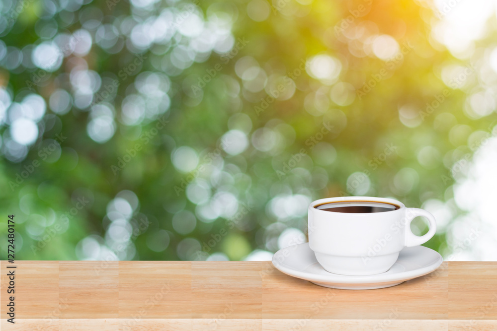 Empty wood table top and coffee cup blur nature background with copy space for display or montage your products Empty wood table top and coffee cup blur nature background with copy space for display or montage your products