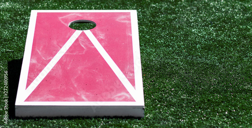 Close up of red and white homemade cornhole game photo