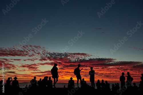 Group of people on coast in evening