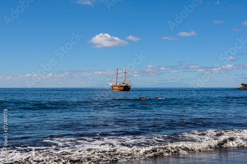 Beautiful and quiet Beach Masca. Pirate ship coming to the island.. Volcanic island. Mountains of the island of Tenerife, Canary Island, Spain photo