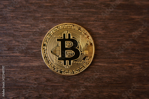 Bitcoin gold coin on dark wood background