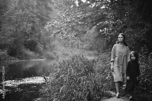 Little girl and mother at the river photo