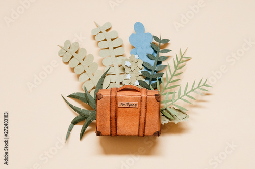 beautiful illustration of a suitcase full of spring vegetation made of paper photo