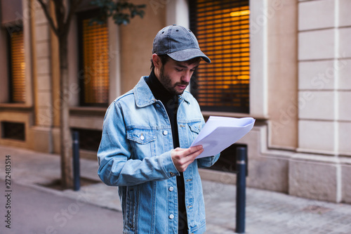 Actor reading script waking on the street. photo