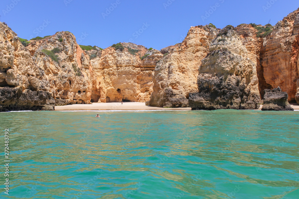 Algarve, panoramic landscape view of golden cliffs and emerald water in Ponta da Piedade, Lagos, Algarve, Portugal