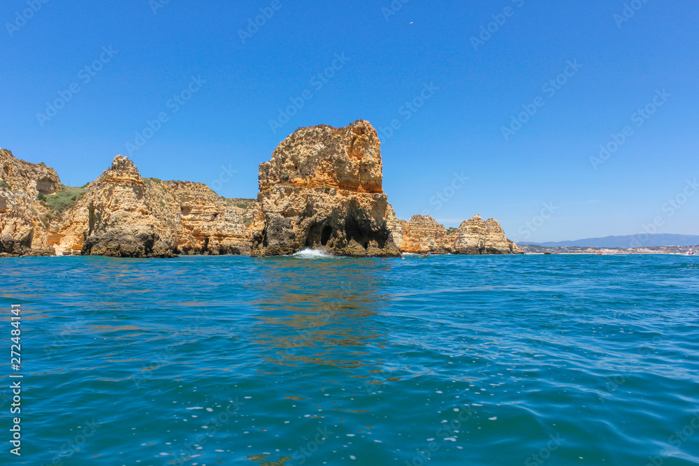 Panoramic landscape view of golden cliffs and emerald water in Ponta da Piedade, Lagos, Algarve, Portugal