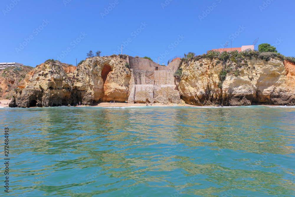 Panoramic landscape view of golden cliffs and emerald water in Ponta da Piedade, Lagos, Algarve, Portugal