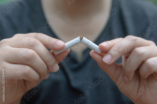 Stop cigarette  woman hands breaking the cigarette with clipping path