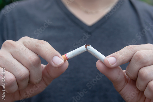 Stop cigarette, woman hands breaking the cigarette with clipping path