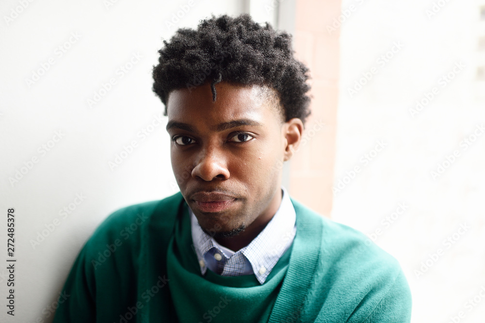 A man indoors near a window A man indoors near a window