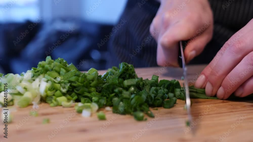 chef cutting green onions in slow motion, close up chef cutting green onions in slow motion, close up