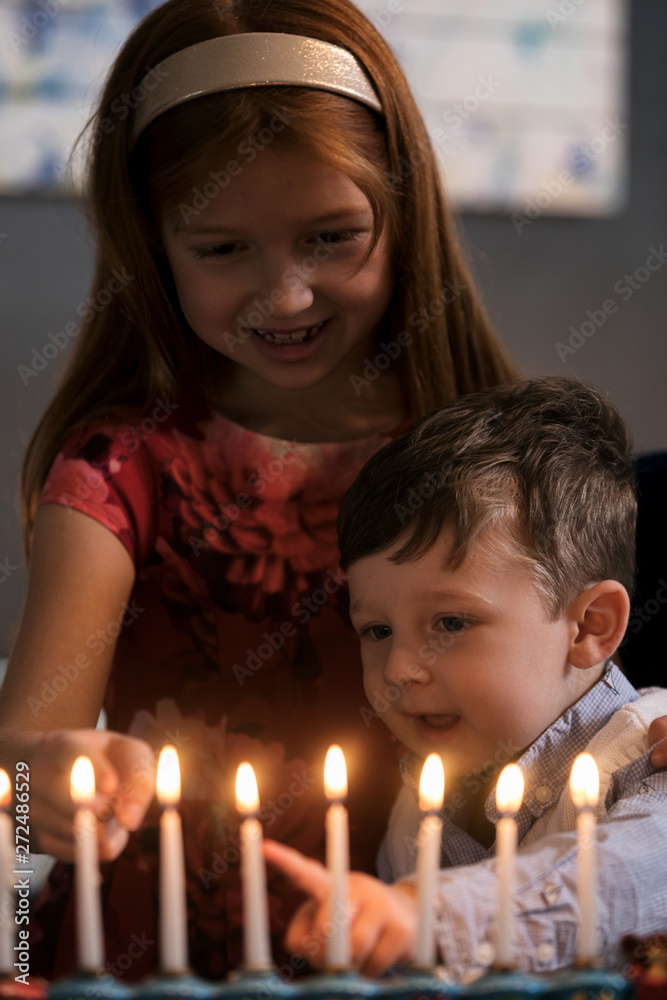 Hanukkah: Siblings Lighting Holiday Candles Hanukkah: Siblings Lighting Holiday Candles