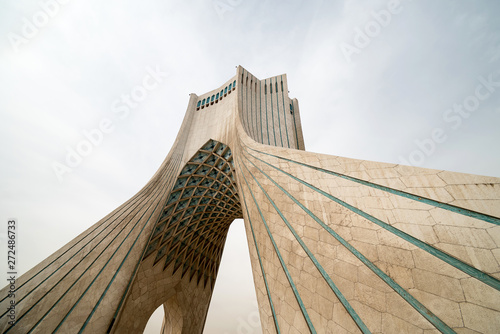 Modern tower and cloudy sky photo