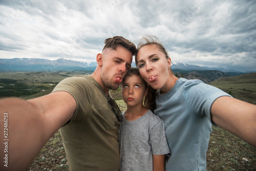 Selfie of family in mountai...