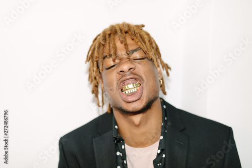 Black boy with gold teeth and cocky attitude
