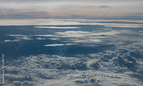 Clouds seen from an airplane  blue sunshine  soil background nature landscape