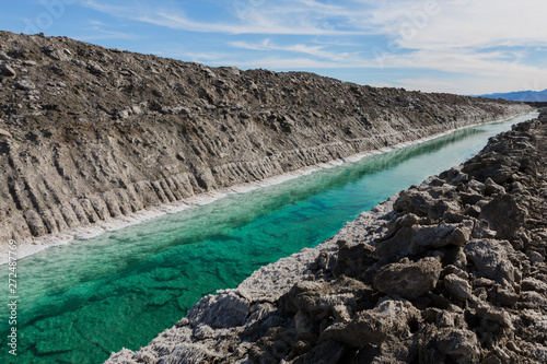 Calcium chloride mine tailings and canal in desert photo