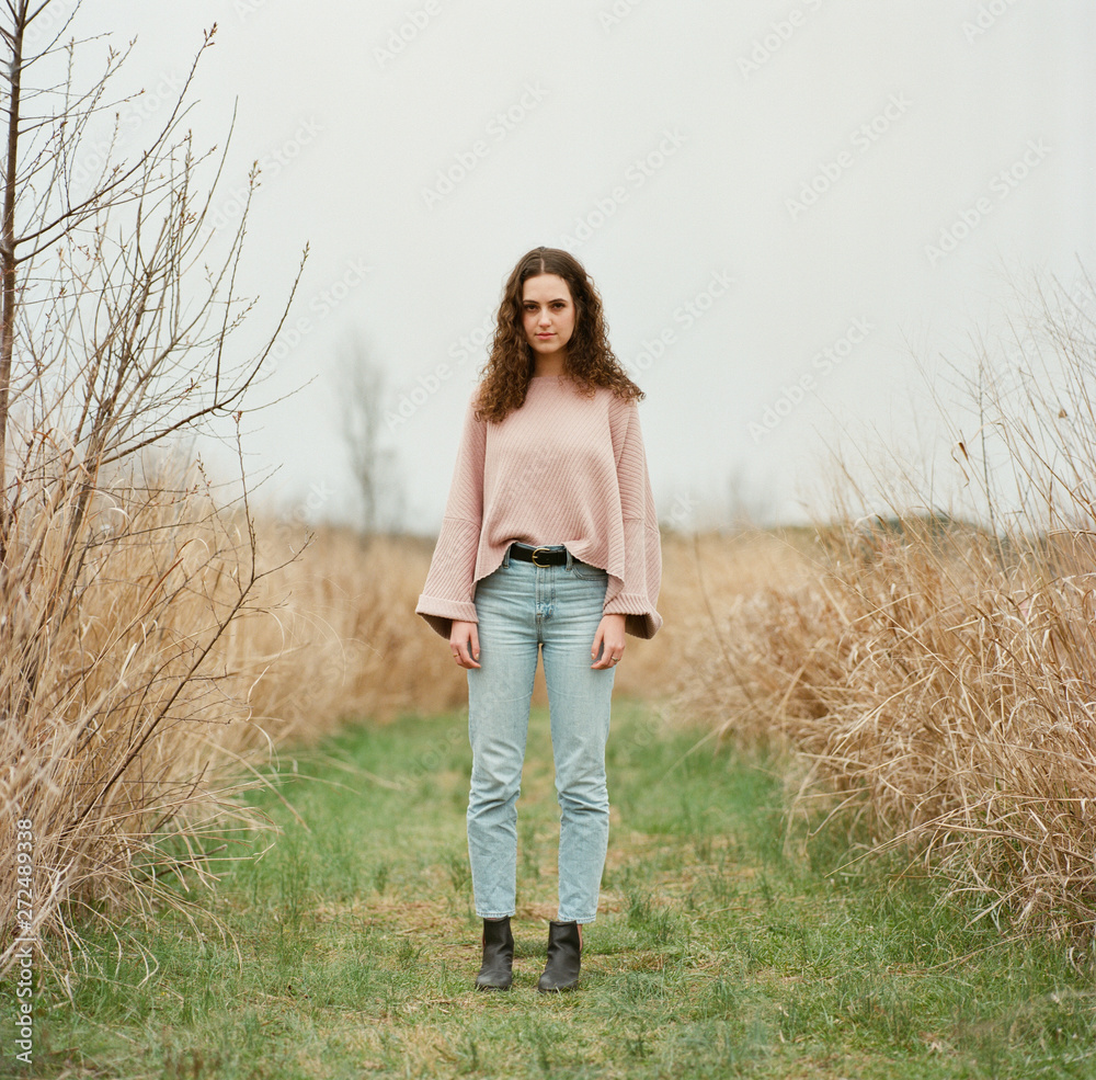 Black and white portrait of a beautiful young woman in a field