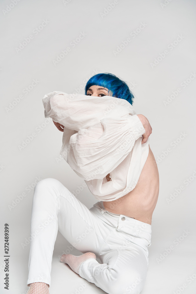 Blue haired young attractive woman undressing Stock Photo Adobe Stock