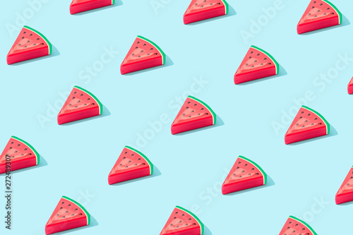 Trendy sunlight Summer pattern made with watermelon fruit on bright light blue background. Minimal summer concept. photo