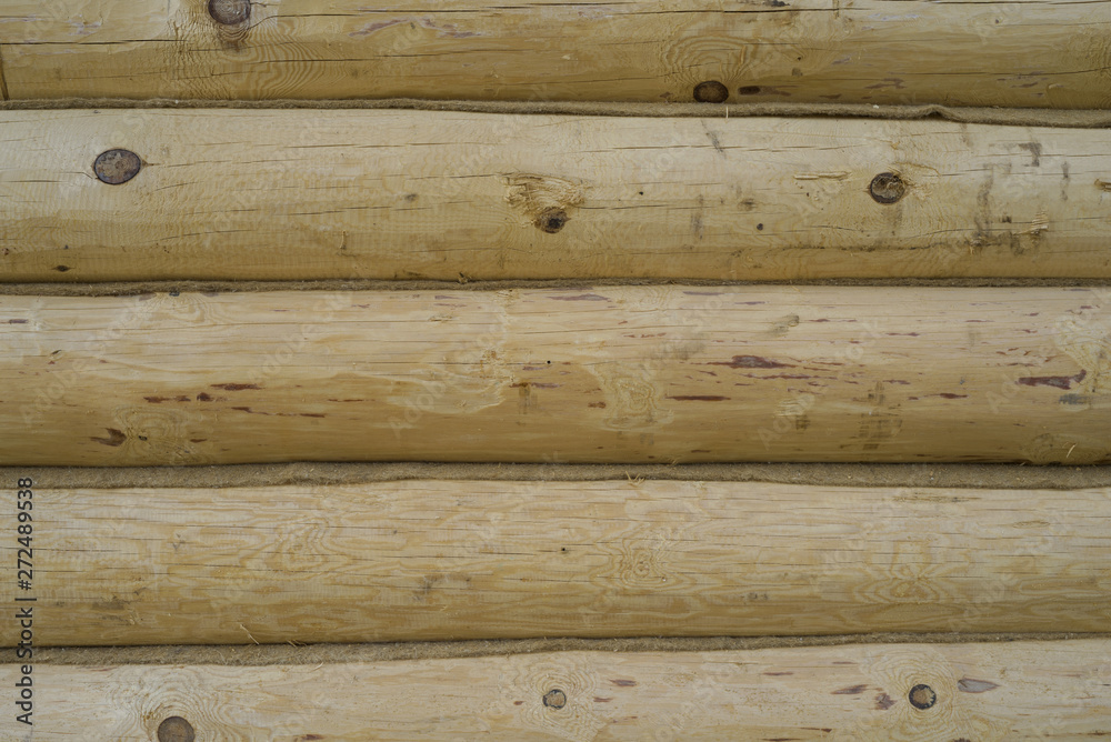 Rustic interior decor. The wall is covered with wooden panels. Wood siding. Rustic interior decor. The wall is covered with wooden panels. Wood siding.