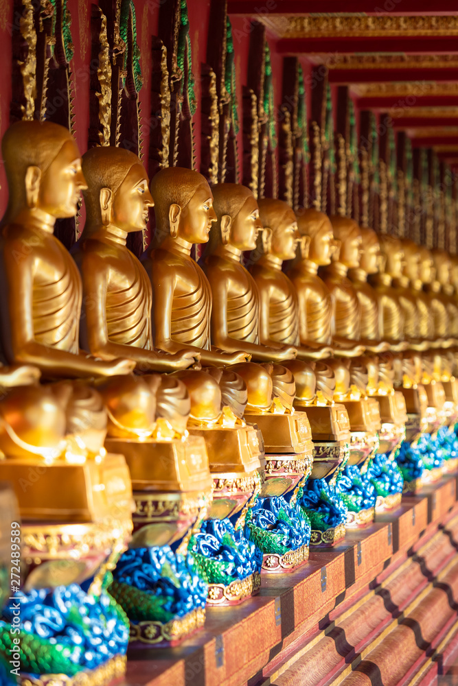 Fototapeta premium Row of Golden Thai's Buddha statue in Wat Bang Thong (Wat Mahathat Wachira Mongkol). It is a beautiful Buddhist temple and famous temple in Krabi, Thailand
