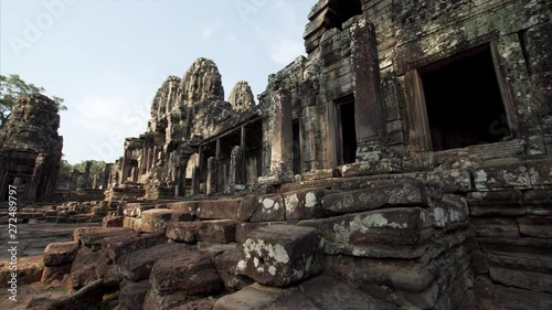 Sliding view of ruins of richly decorated Bayon temple in Angkor Wat complex, built in 12th cetury by khmer civilization. Cambodia photo