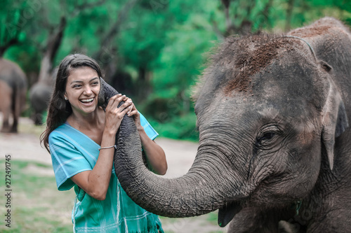 Girl having fun with elephants at Patara Elephant Farm, Chiang Mai, Thailand
