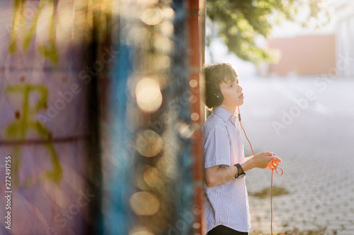 Boy with headphones listening to a music device
