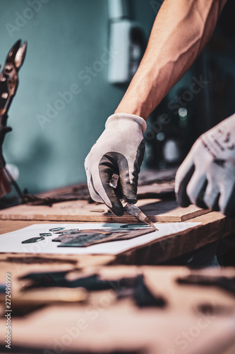 Process of restouration an old broken stained glass by expirienced master at his workshop.