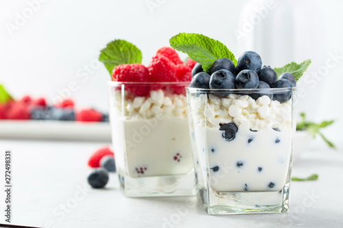 Принти на полотні Cottage cheese with cream, raspberry and blueberry garnished with fresh mint