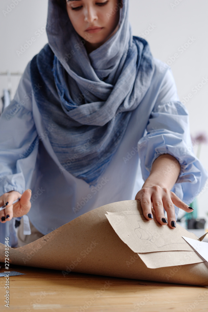 Woman with sewing patterns at table Woman with sewing patterns at table