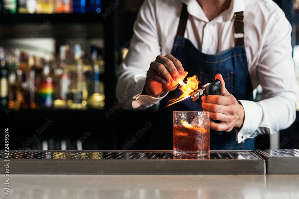 Unrecognizable professional young bartender working into night club