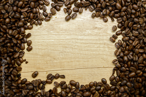Roasted coffee beans on rustic wooden table background