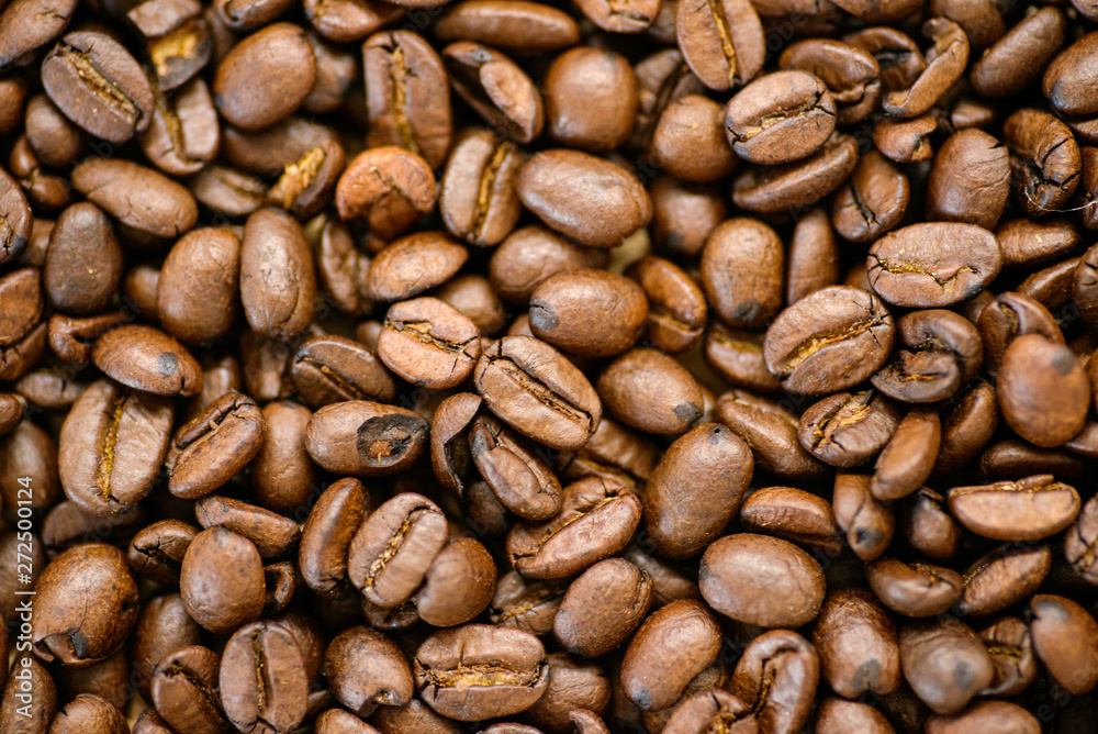 Roasted coffee beans on rustic wooden table background Roasted coffee beans on rustic wooden table background