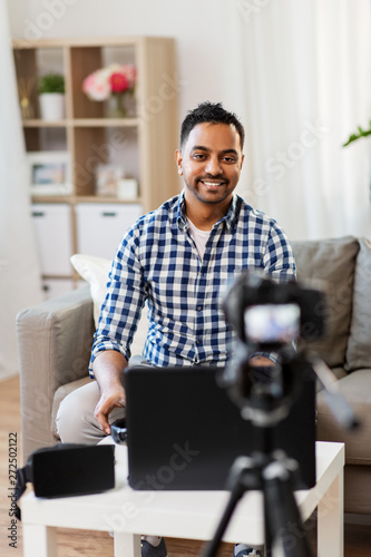 blogging, videoblog and people concept - indian male blogger with camera recording video at home