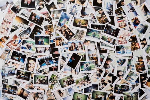 Many polaroid pics scattered on the floor. photo