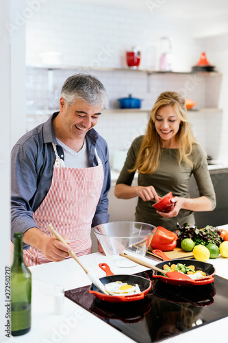 Married couple cooking together at home