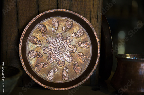 Copper plate handcrafted, traditionally made in Lagich, Azerbaijan. Handmade plate in souvenir shop.