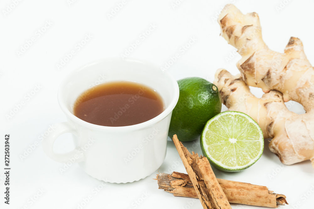 Drink made with ginger root, lemon and cinnamon; photo on neutral background Drink made with ginger root, lemon and cinnamon; photo on neutral background