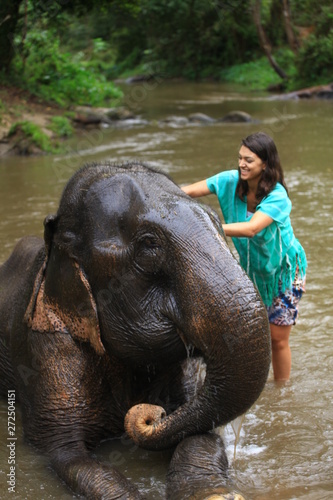 Girl having fun with elephants at Patara Elephant Farm, Chiang Mai, Thailand