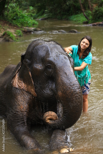 Photography Girl having fun with elephants at Patara Elephant Farm, Chiang Mai, Thailand